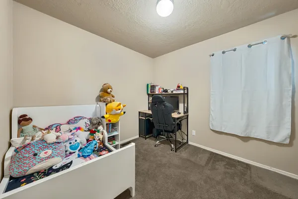 an empty room with a dresser