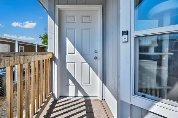 a view of staircase with lots of frames on wall and a window