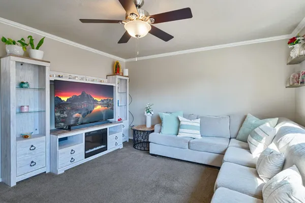 a living room with furniture and a flat screen tv