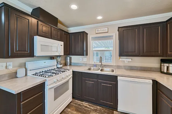 a kitchen with stainless steel appliances a sink stove and cabinets