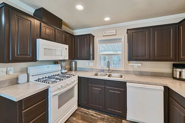 a kitchen with stainless steel appliances a sink stove and cabinets