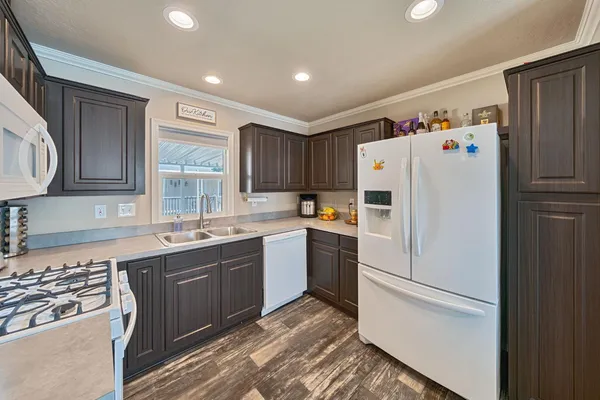 a white refrigerator freezer sitting inside of a kitchen