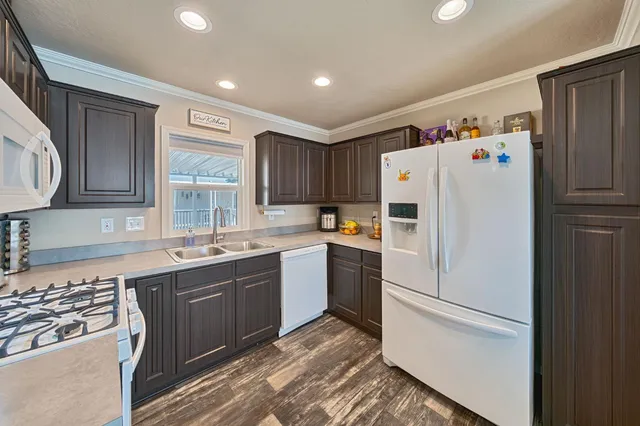 a white refrigerator freezer sitting inside of a kitchen