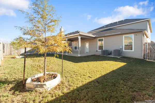 a view of a house with a backyard