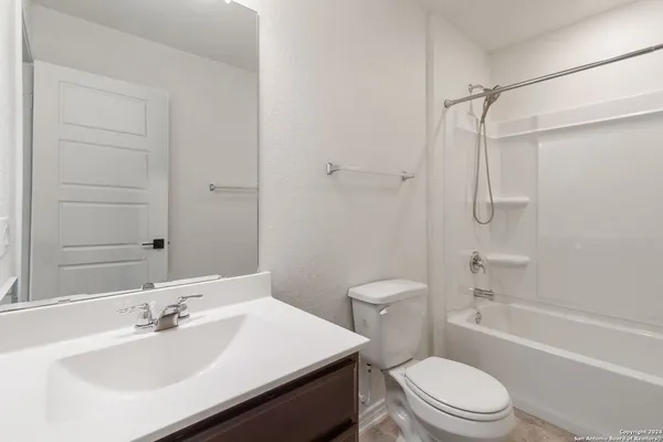 a bathroom with a sink toilet vanity and shower