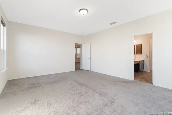 a view of a big room with closet and windows