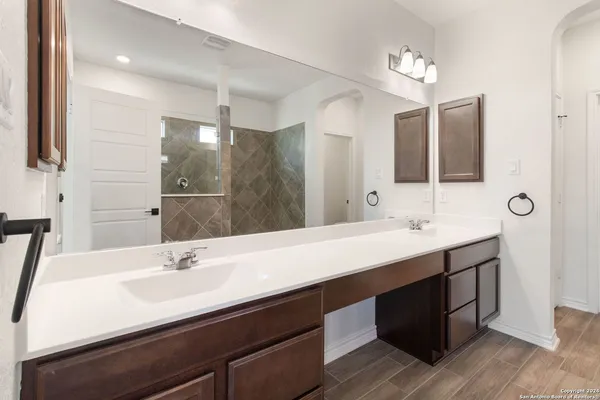 a bathroom with a sink double vanity and a mirror