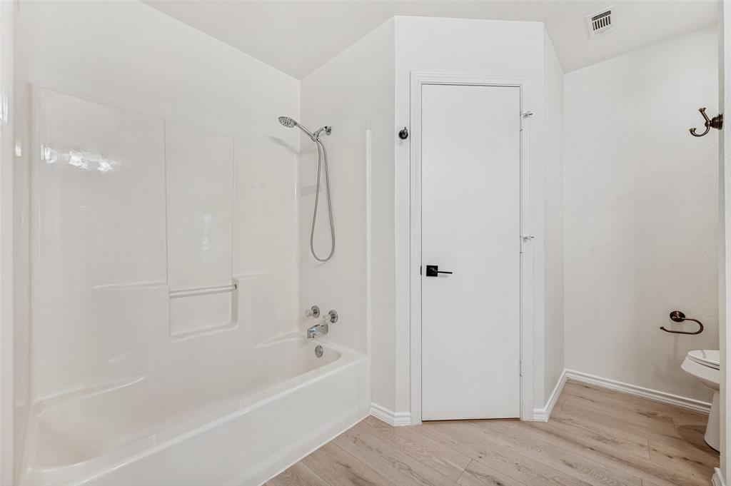 629 Concho Drive Oak Point, TX 75068 - Photo 22 of 35 a bathroom with a bathtub and a shower