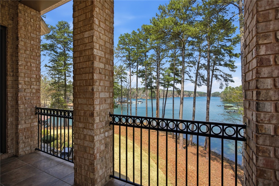 610 Highridge Drive Seneca, SC 29672 - Photo 21 of 50 This serene balcony offers expansive views of the tranquil Lake Keowee and lush surrounding landscape.