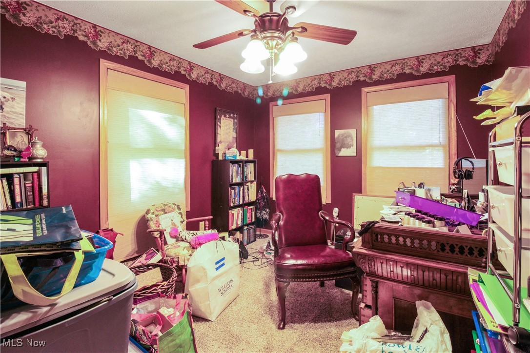 2632 Berry Road Akron, OH 44320 - Photo 18 of 39 Living area featuring carpet floors, a healthy amount of sunlight, and ceiling fan