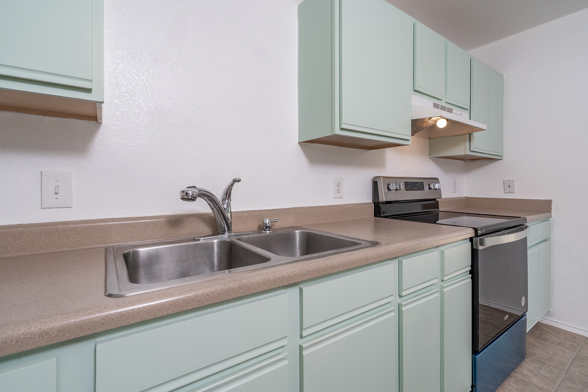 1305 Water Spaniel Way Round Rock, TX 78664 - Photo 12 of 27 a kitchen with stainless steel appliances granite countertop a sink and a white cabinets