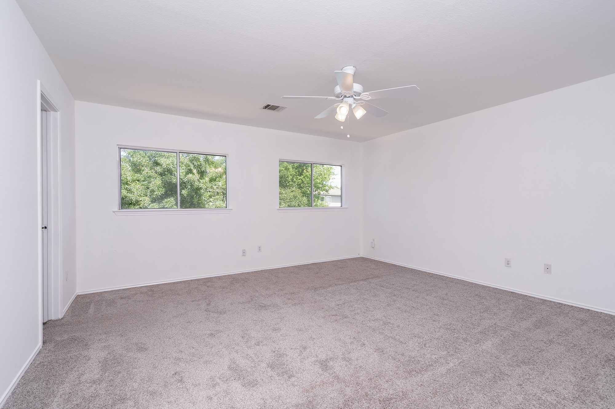 1305 Water Spaniel Way Round Rock, TX 78664 - Photo 16 of 27 an empty room with windows and fan