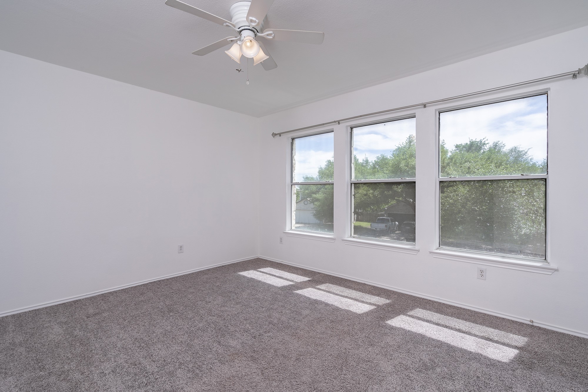 1305 Water Spaniel Way Round Rock, TX 78664 - Photo 20 of 27 an empty room with a window and a ceiling fan