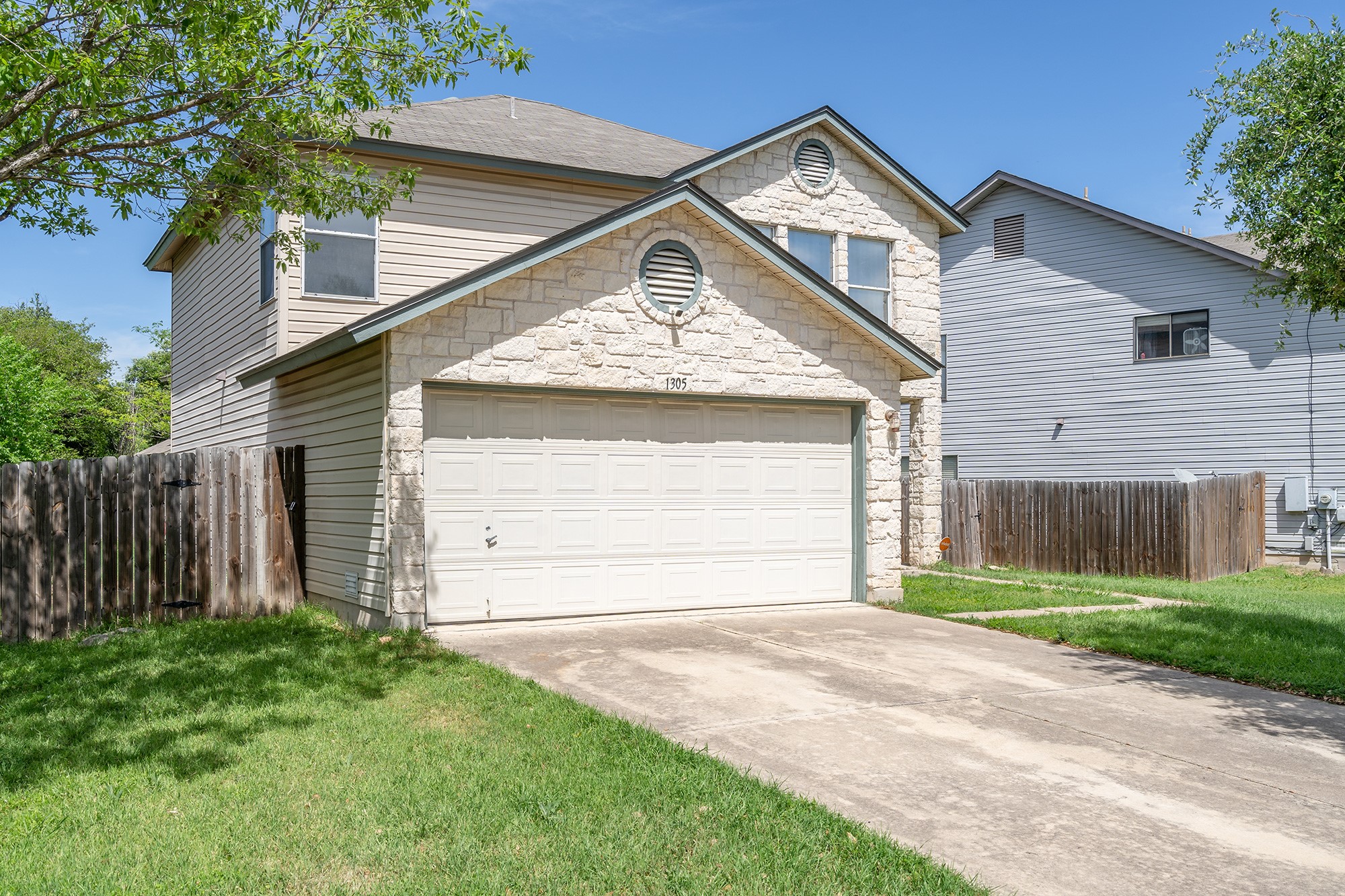 1305 Water Spaniel Way Round Rock, TX 78664 - Photo 2 of 27 a front view of a house with a yard and garage