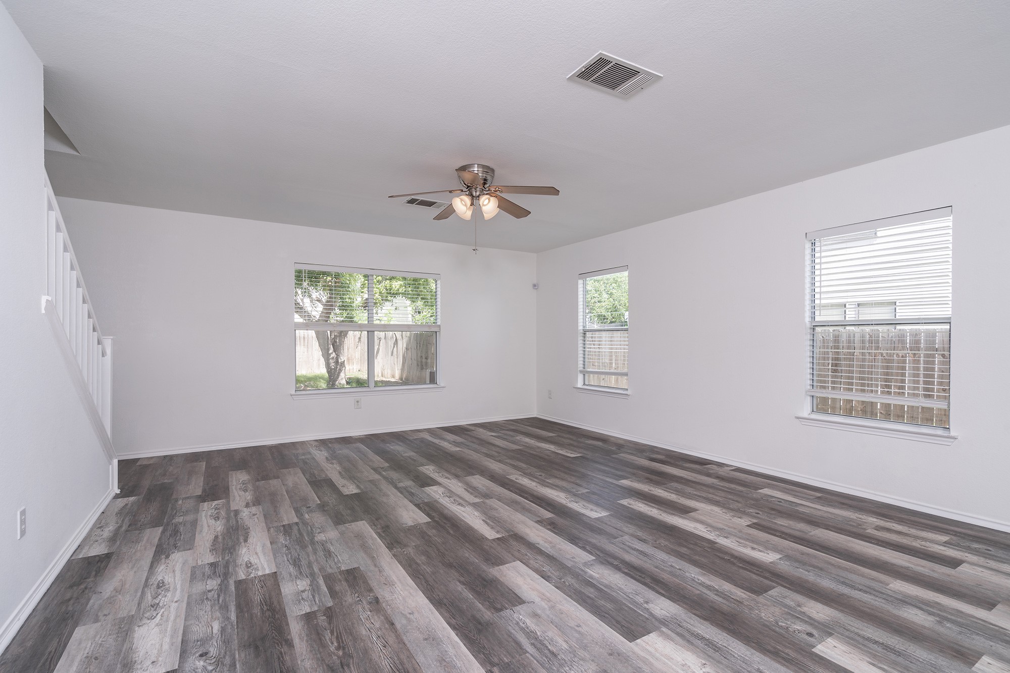 1305 Water Spaniel Way Round Rock, TX 78664 - Photo 8 of 27 wooden floor in an empty room with a window