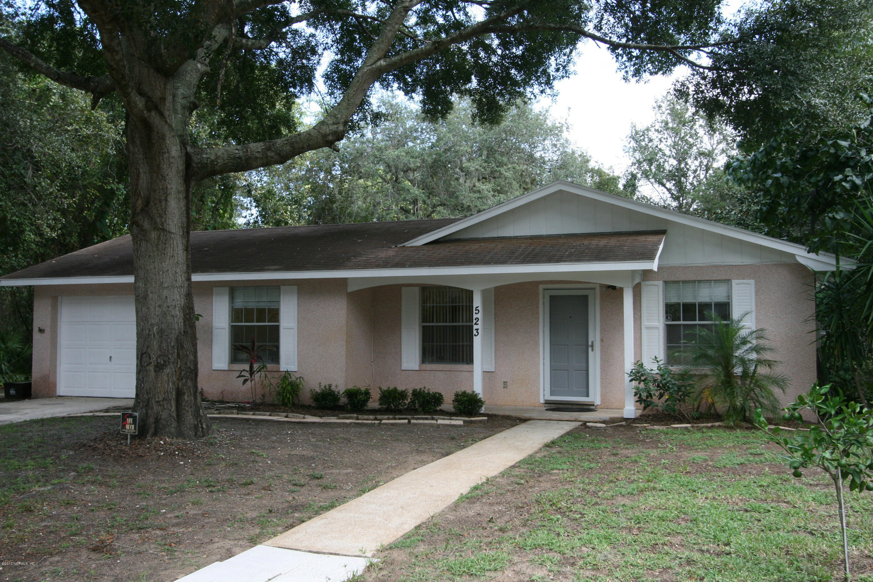 523 Gentian Road St. Augustine, FL 32086 - Photo 1 of 26 a front view of a house with yard and trees