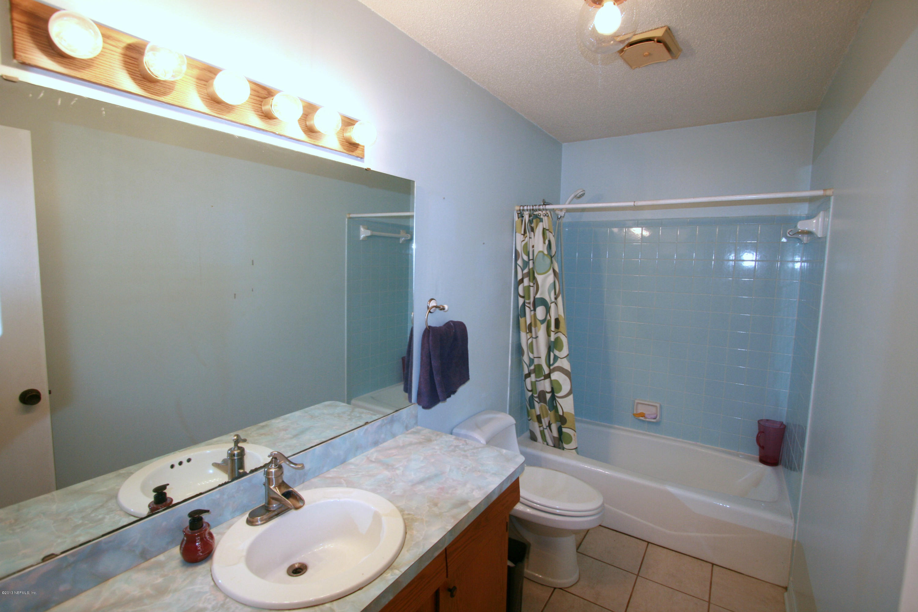 523 Gentian Road St. Augustine, FL 32086 - Photo 14 of 26 a bathroom with a sink toilet and shower