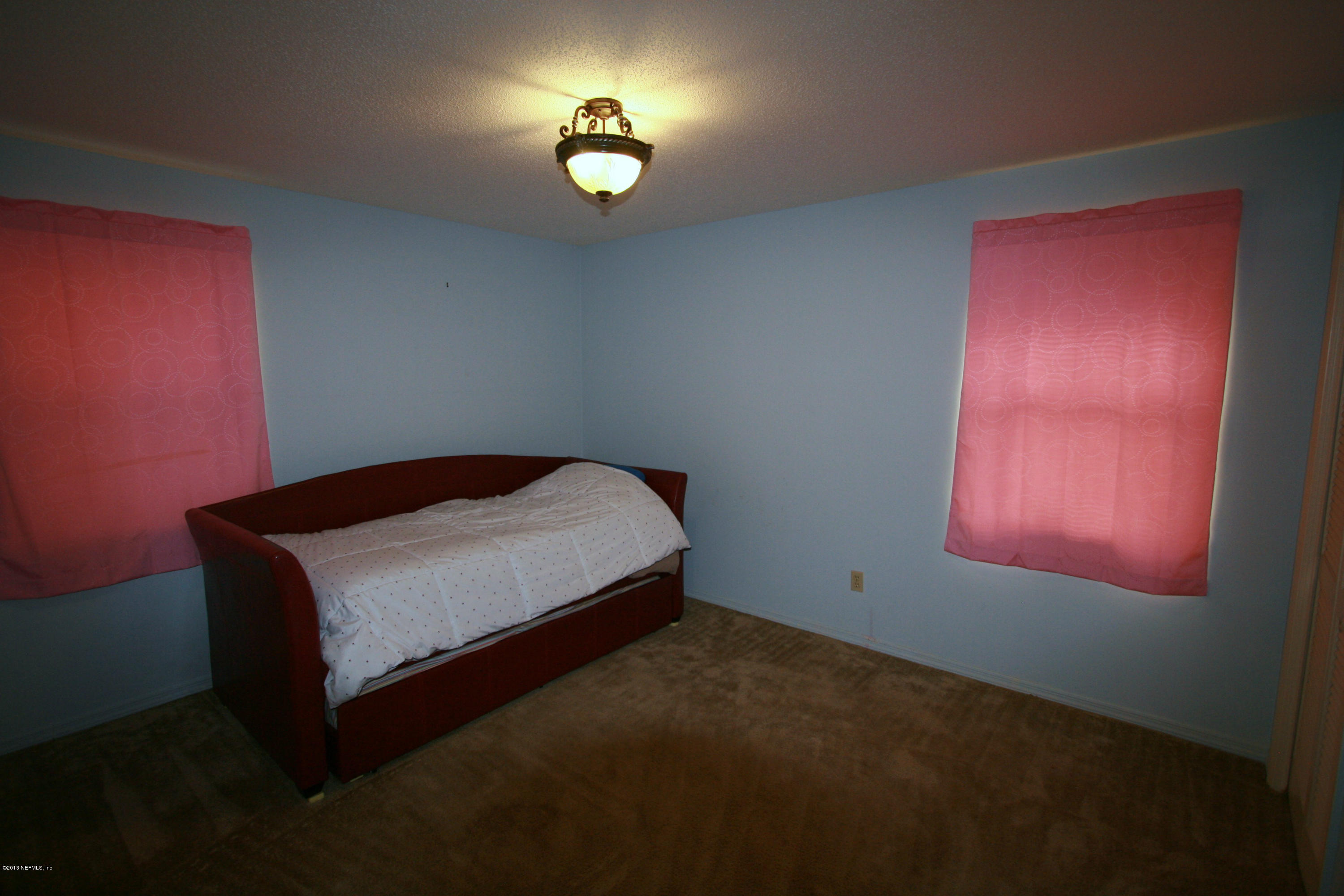 523 Gentian Road St. Augustine, FL 32086 - Photo 16 of 26 a bedroom with a bed and a window