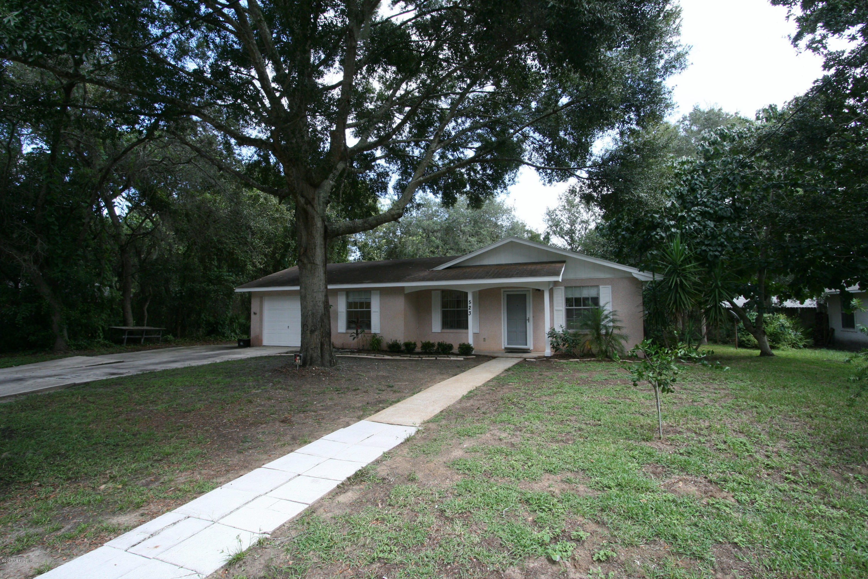 523 Gentian Road St. Augustine, FL 32086 - Photo 2 of 26 a front view of a house with a garden