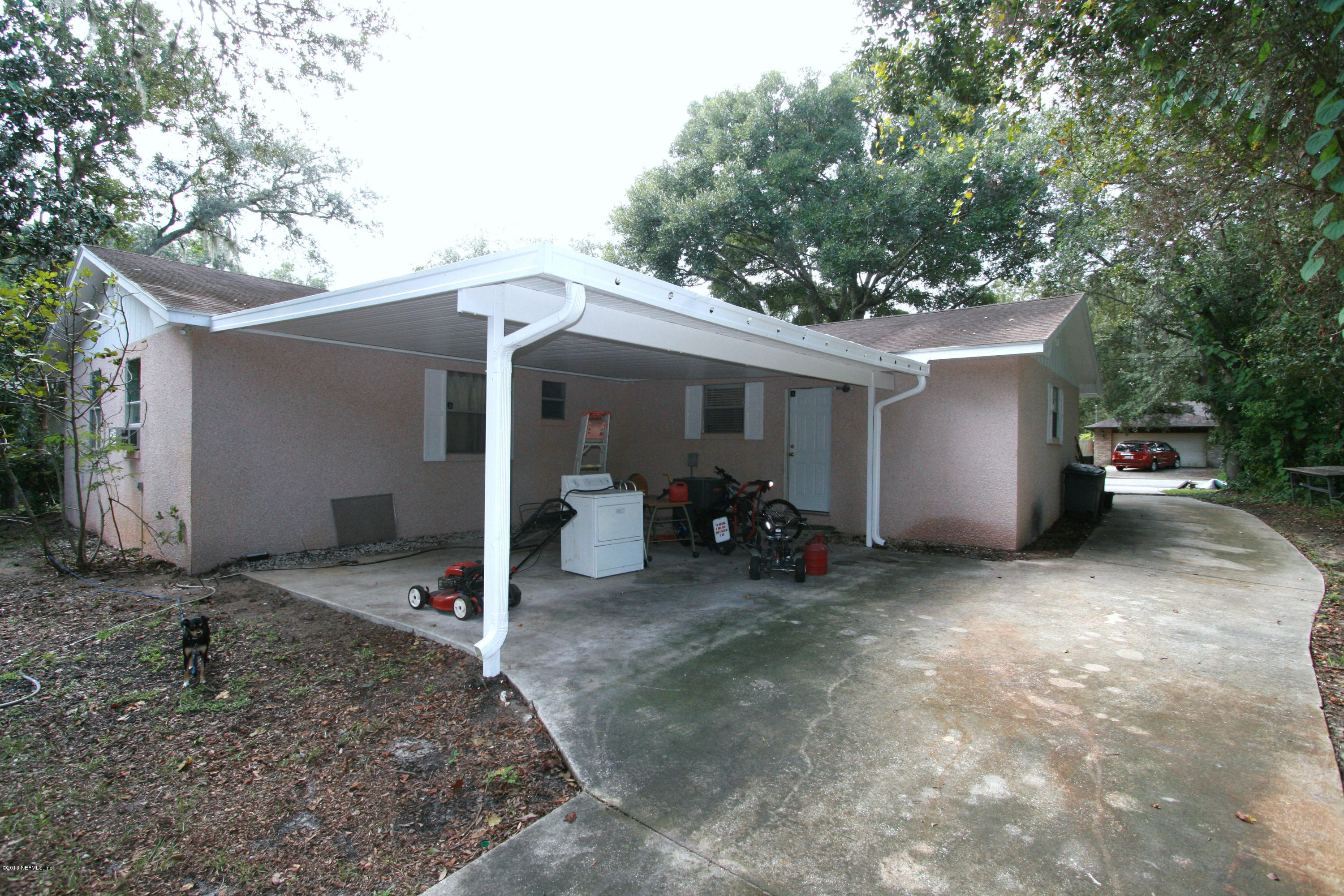 523 Gentian Road St. Augustine, FL 32086 - Photo 22 of 26 a view of a garage with parked cars