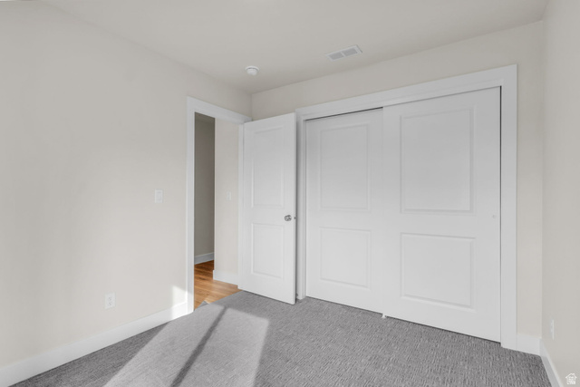 578 West 7th Midvale, UT 84047 - Photo 20 of 35 Unfurnished bedroom featuring carpet floors and a closet