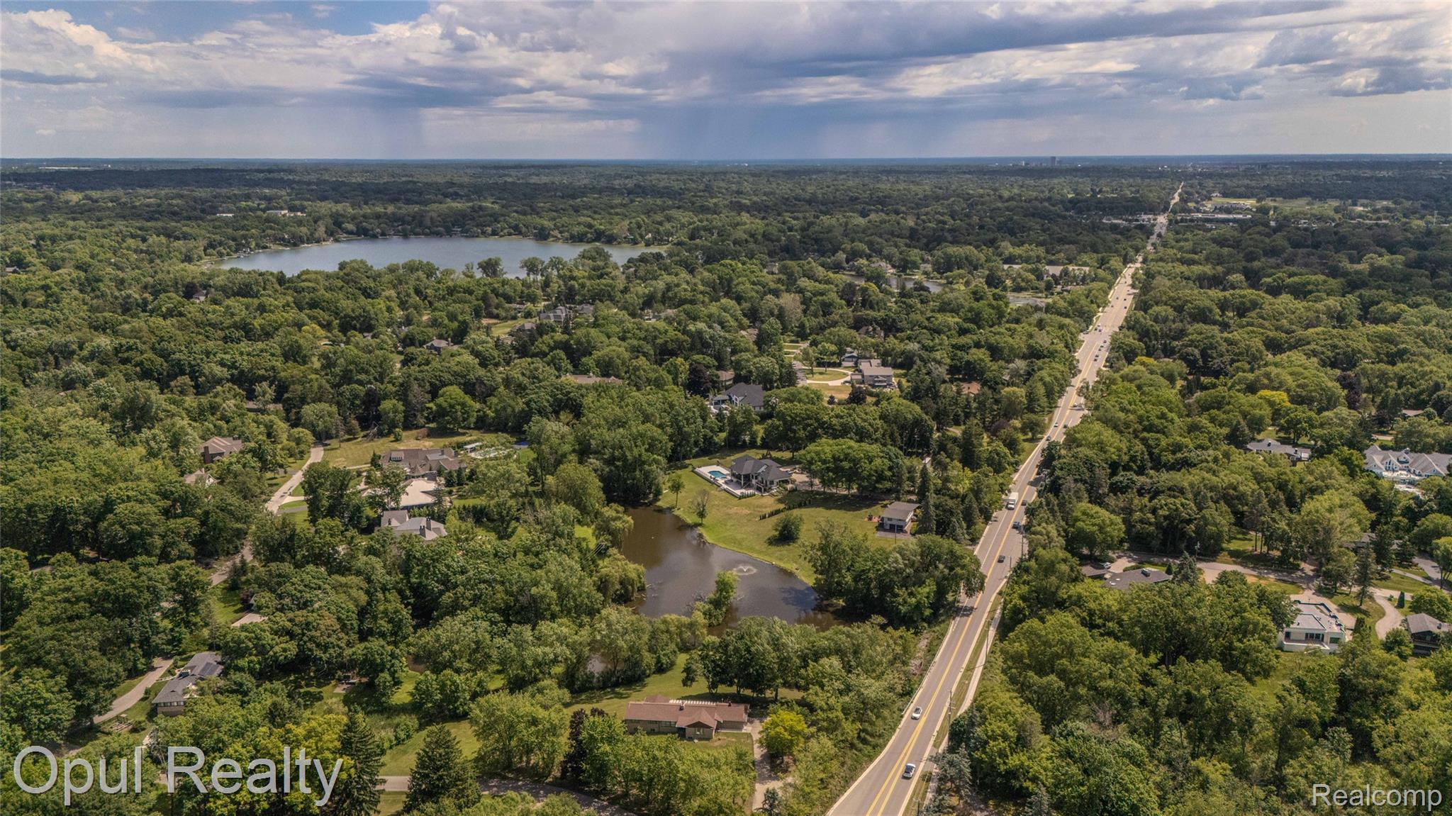 6455 Norham Road Bloomfield Hills, MI 48301 - Photo 73 of 93 Expansive aerial perspective showcasing a residential area with extensive tree coverage and two bodies of water
