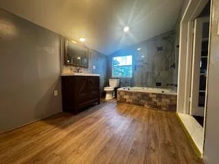 a spacious bathroom with a bathtub sink and mirror