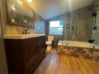 a bathroom with a tub a toilet and a shower