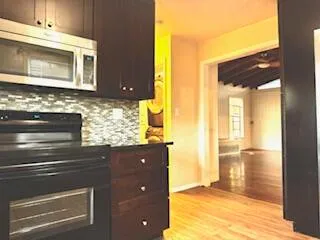 a kitchen with granite countertop a sink and a stove