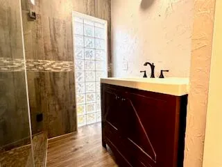 a kitchen with a sink a mirror and shower