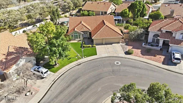 an aerial view of a house with a yard and garden