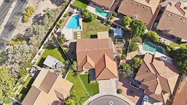 an aerial view of a house with swimming pool and glass windows