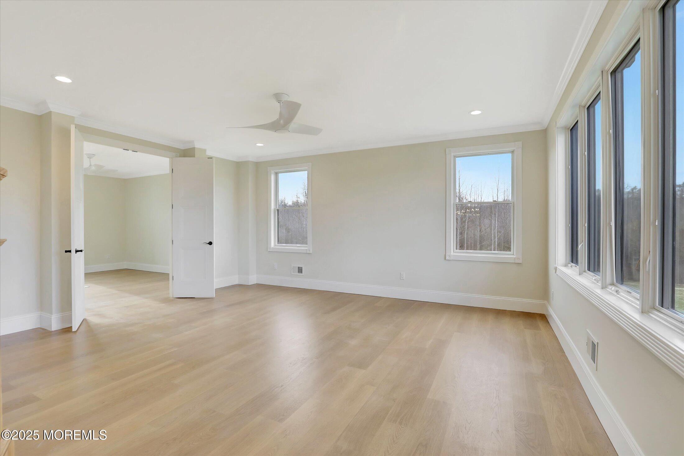 12 Cook Court Millstone Township, NJ 08535 - Photo 11 of 54 a view of an empty room with a window and wooden floor