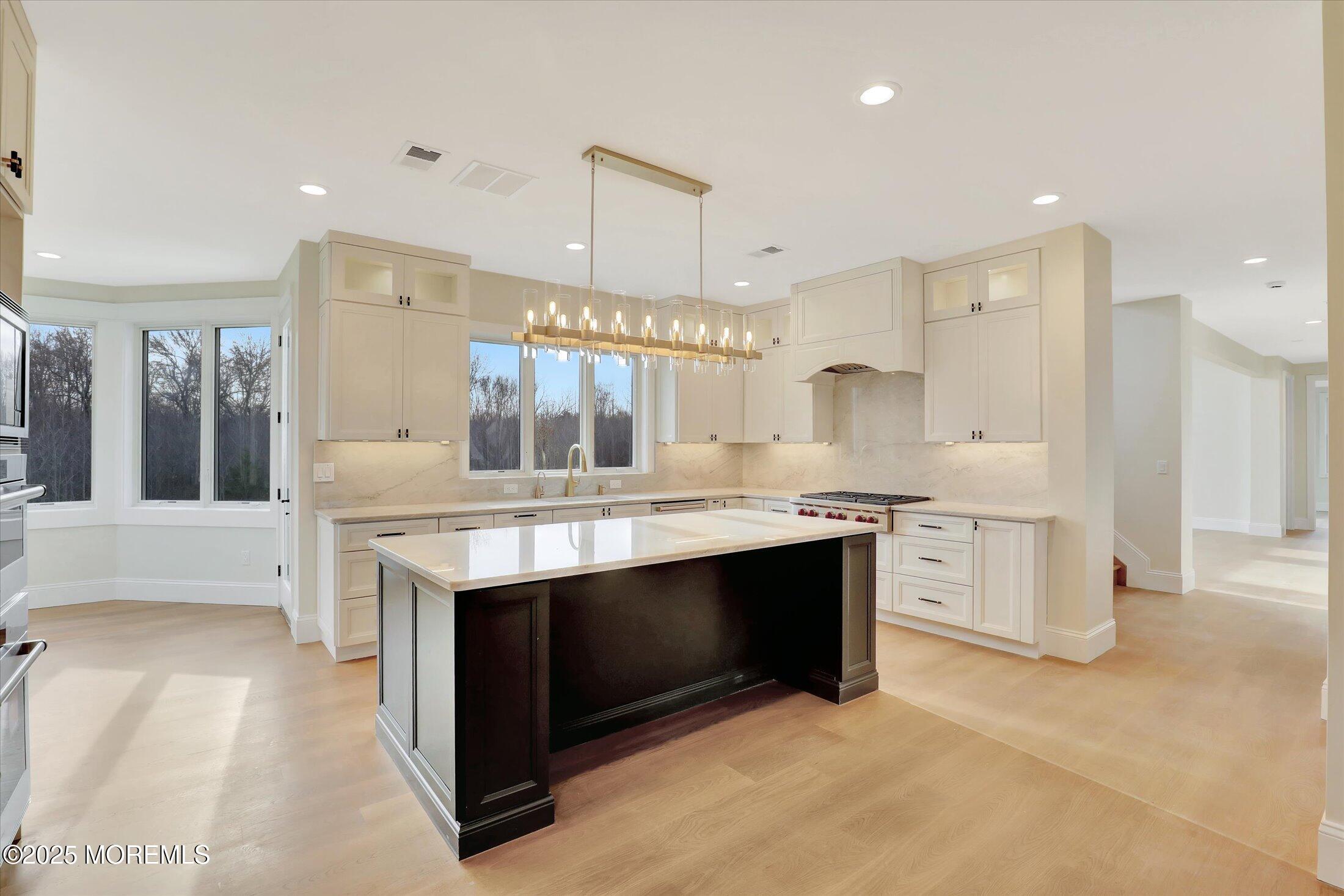 12 Cook Court Millstone Township, NJ 08535 - Photo 13 of 54 a kitchen with stainless steel appliances granite countertop a stove and a sink
