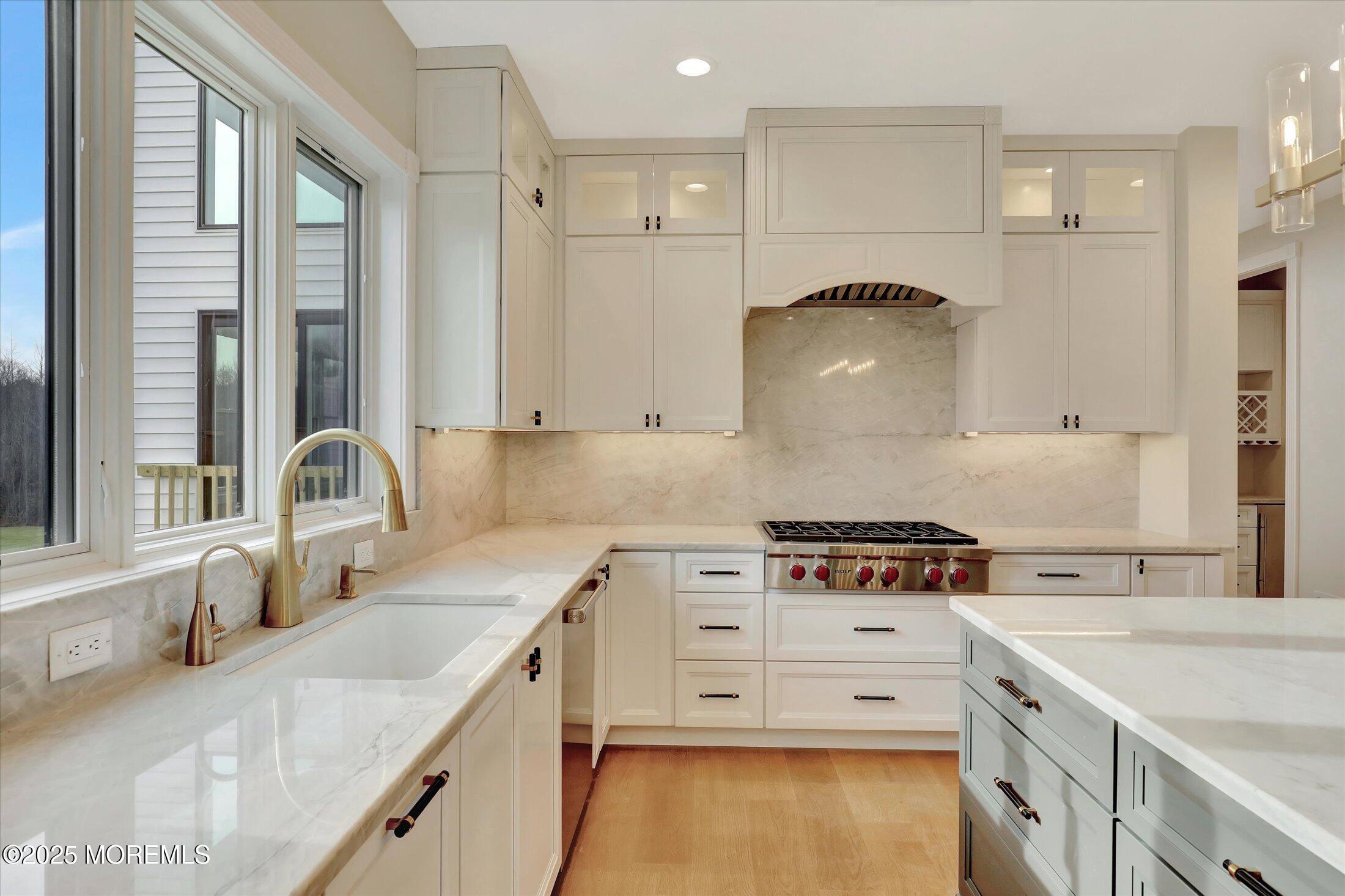 12 Cook Court Millstone Township, NJ 08535 - Photo 14 of 54 a kitchen that has a sink a stove and a wooden floor