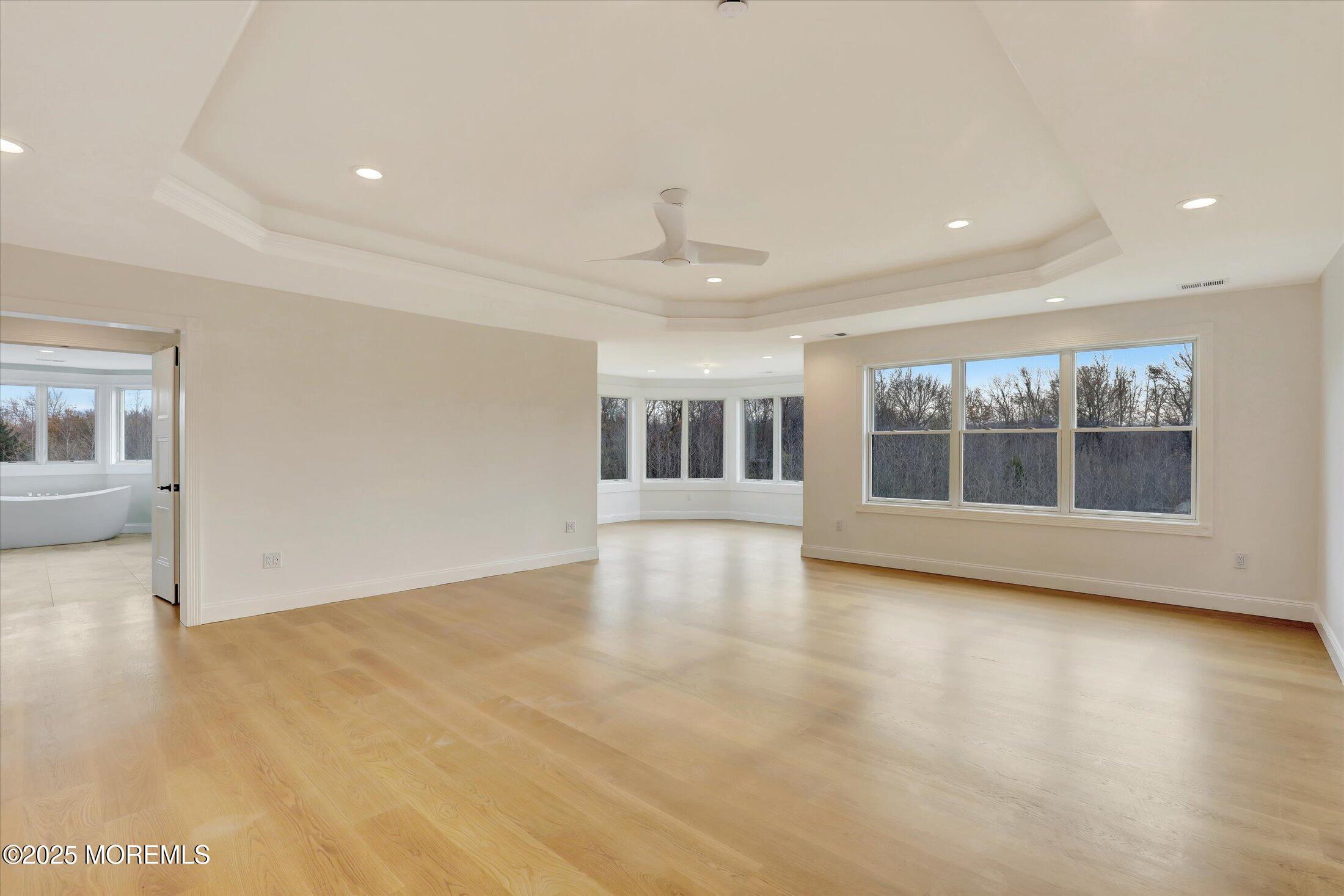 12 Cook Court Millstone Township, NJ 08535 - Photo 15 of 54 a view of empty room with wooden floor and fireplace