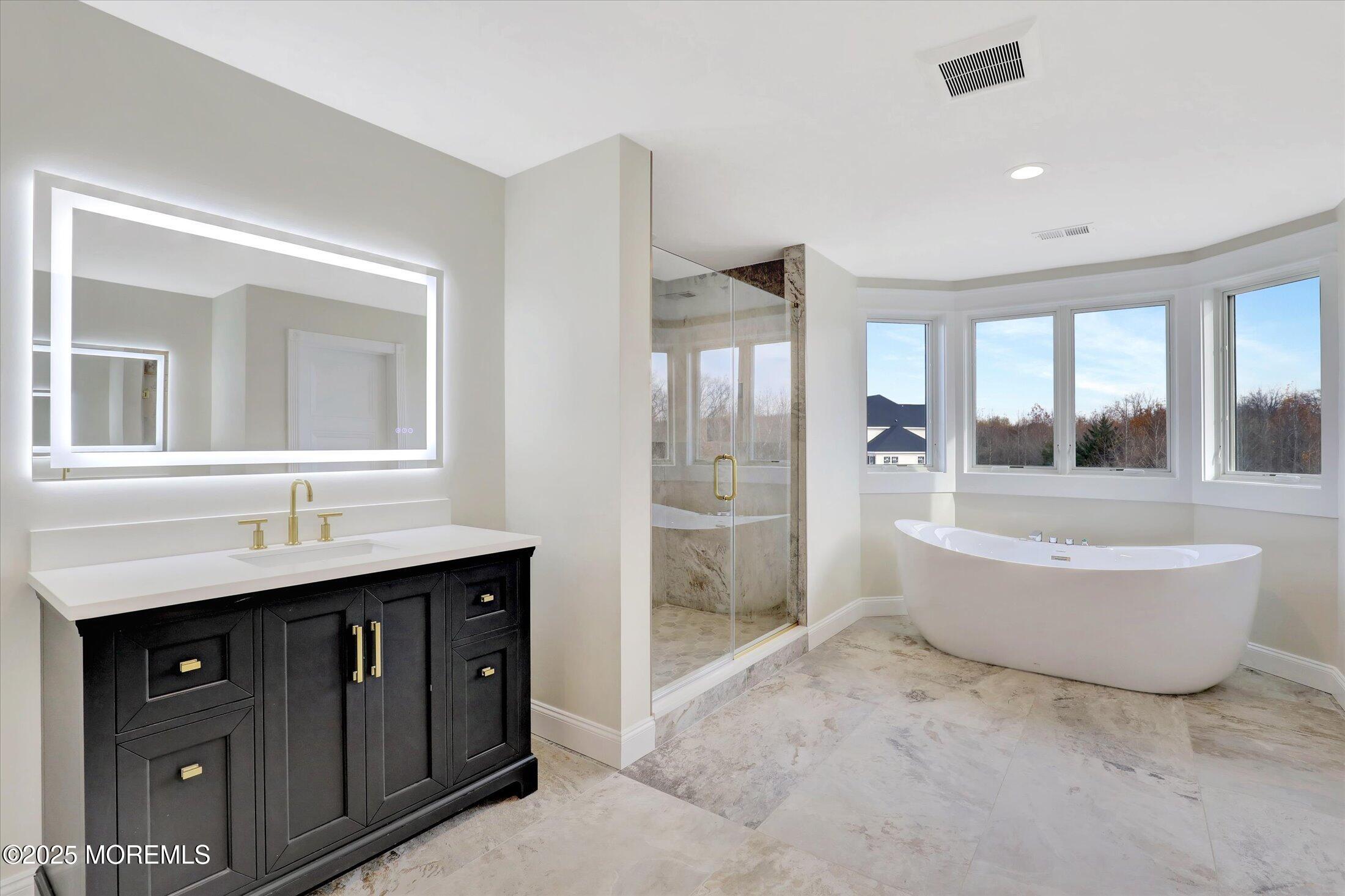 12 Cook Court Millstone Township, NJ 08535 - Photo 17 of 54 a bathroom with a tub sink shower and mirror