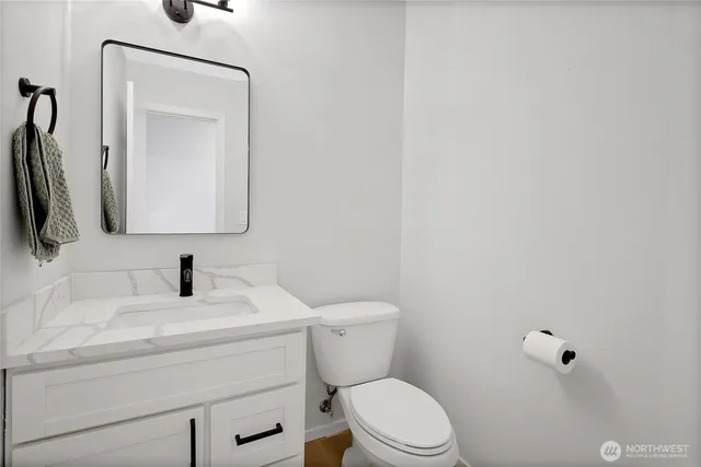 a bathroom with a toilet sink and mirror