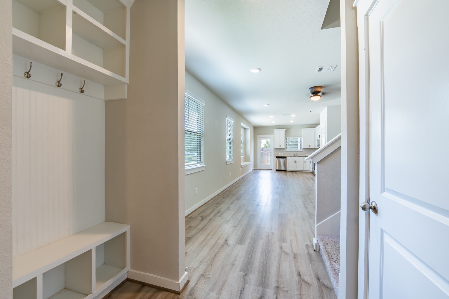 147 Waterside Road, Unit A Buda, TX 78610 - Photo 9 of 27 A well-lit, open-concept living space features light-toned flooring and a built-in entry organizer.