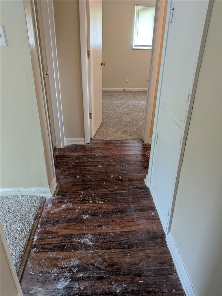 840 Brookfield Road Kettering, OH 45429 - Photo 8 of 13 This interior hallway connects rooms with contrasting yet complementary flooring options.