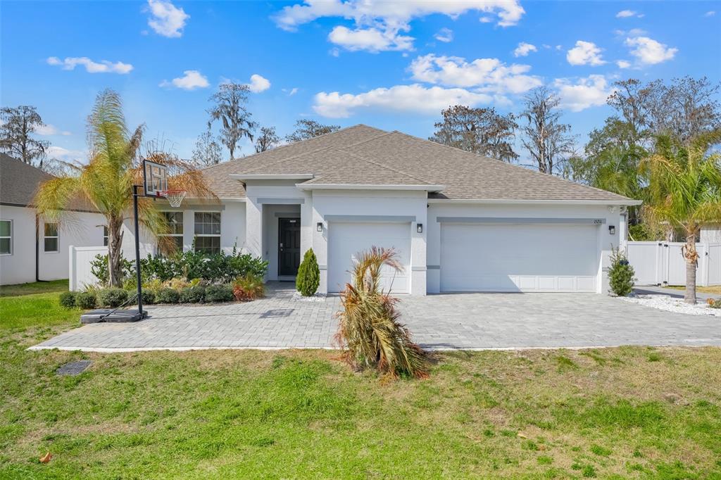 15211 Silver Eagle Road Groveland, FL 34736 - Photo 1 of 1 a house view with a garden space