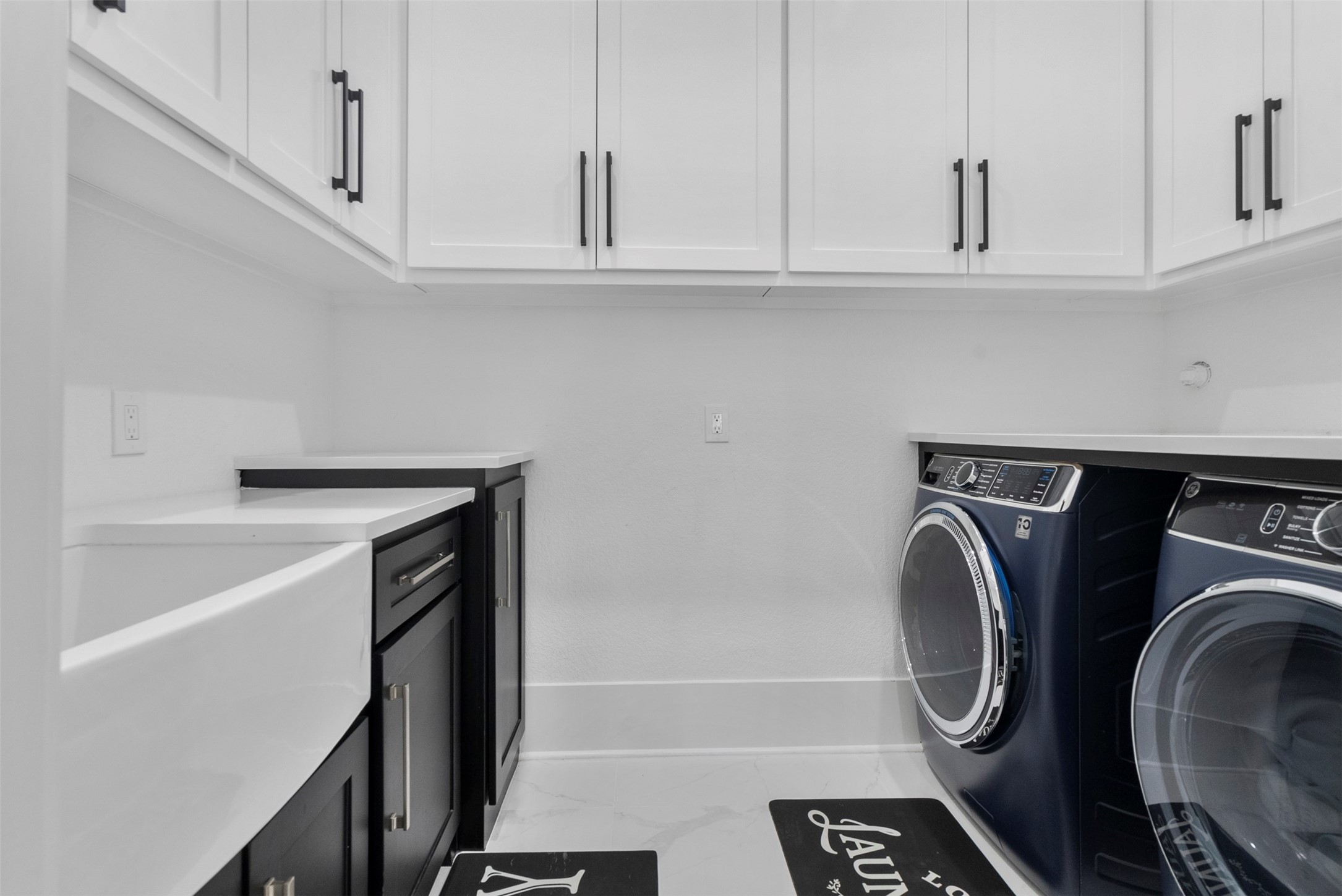 12 County Road 3558 Cleveland, TX 77327 - Photo 19 of 50 Functional laundry room featuring ample cabinet storage, spacious countertops, and a convenient built-in sink.