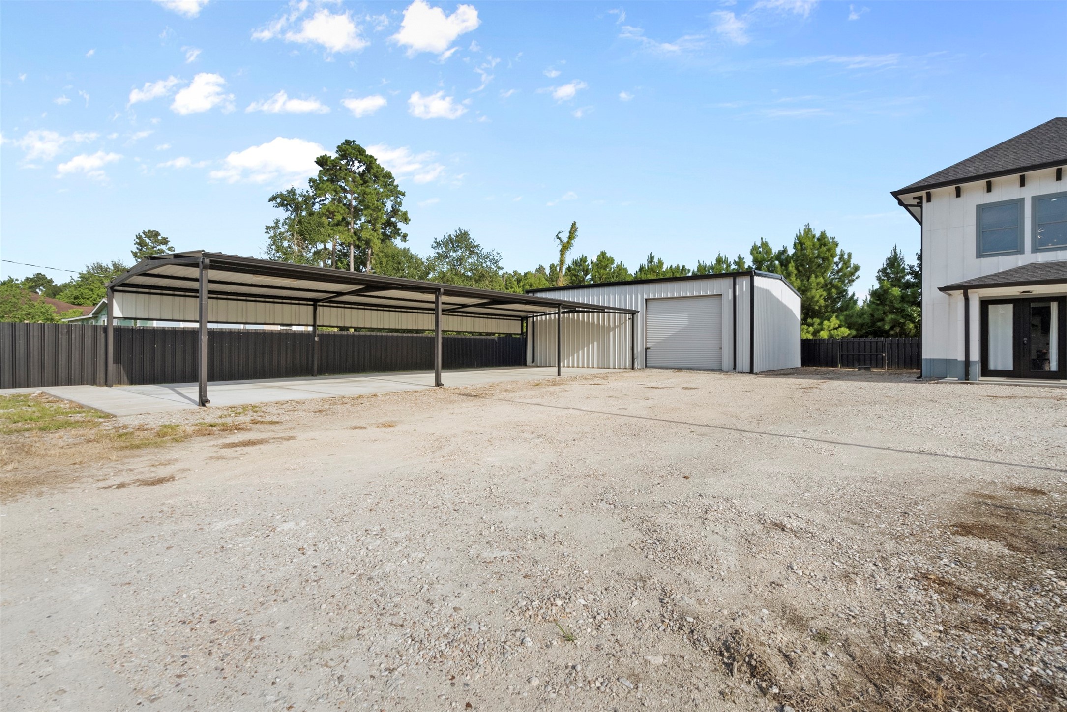 12 County Road 3558 Cleveland, TX 77327 - Photo 48 of 50 Expansive carport connected to 2nd warehouse