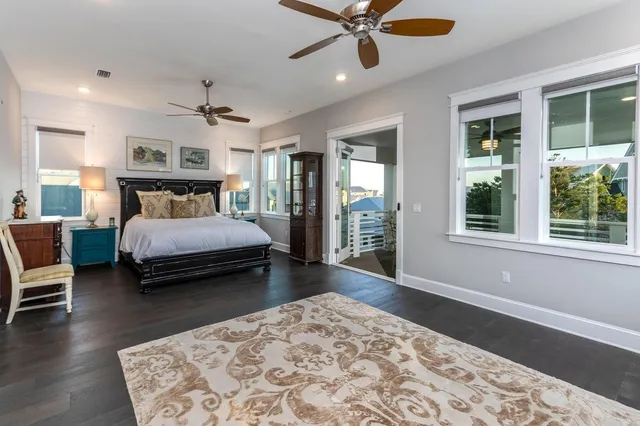 a bedroom with a bed ceiling fan and a window