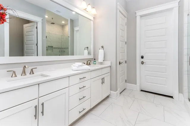 a bathroom with a granite countertop sink mirror and
