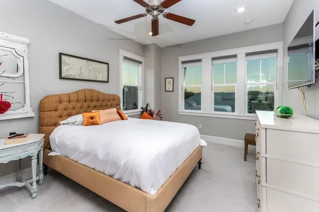 a bedroom with a bed and a large window