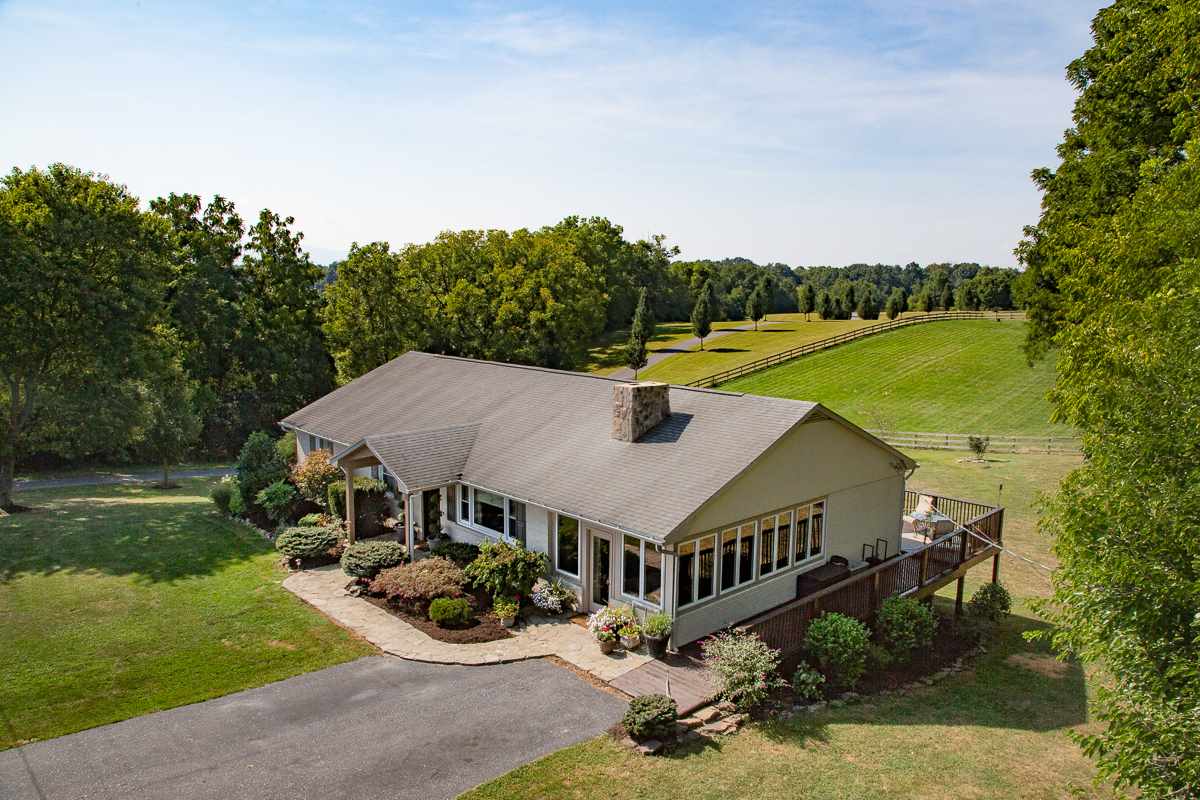 an aerial view of a house having yard and green space
