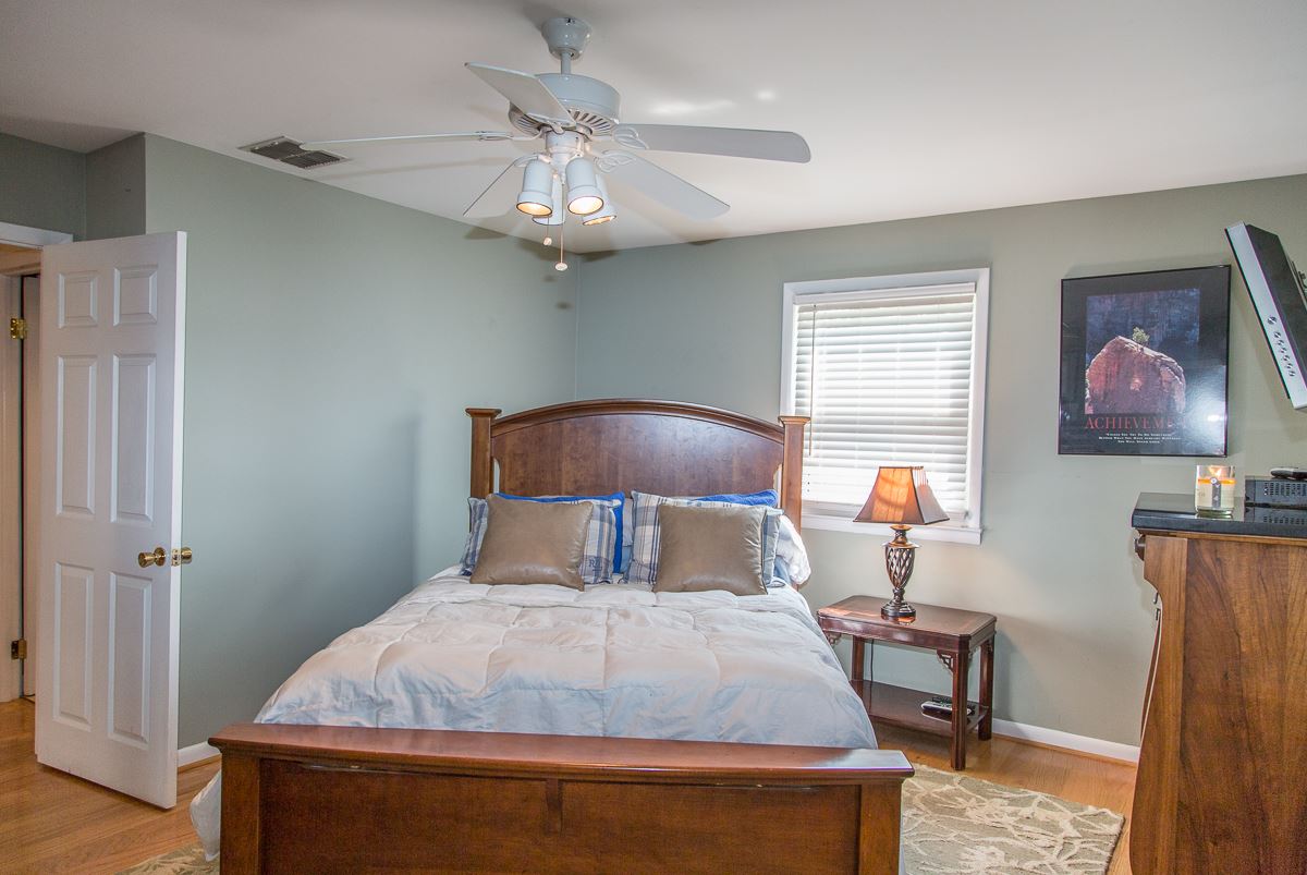 5720 Battlefield Road Harrisonburg, VA 22801 - Photo 22 of 41 a bedroom with a bed and a chandelier