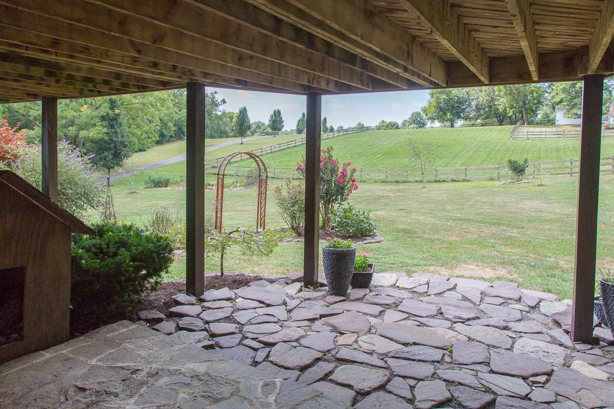 5720 Battlefield Road Harrisonburg, VA 22801 - Photo 34 of 41 a view of a porch with a table and chairs next to a yard