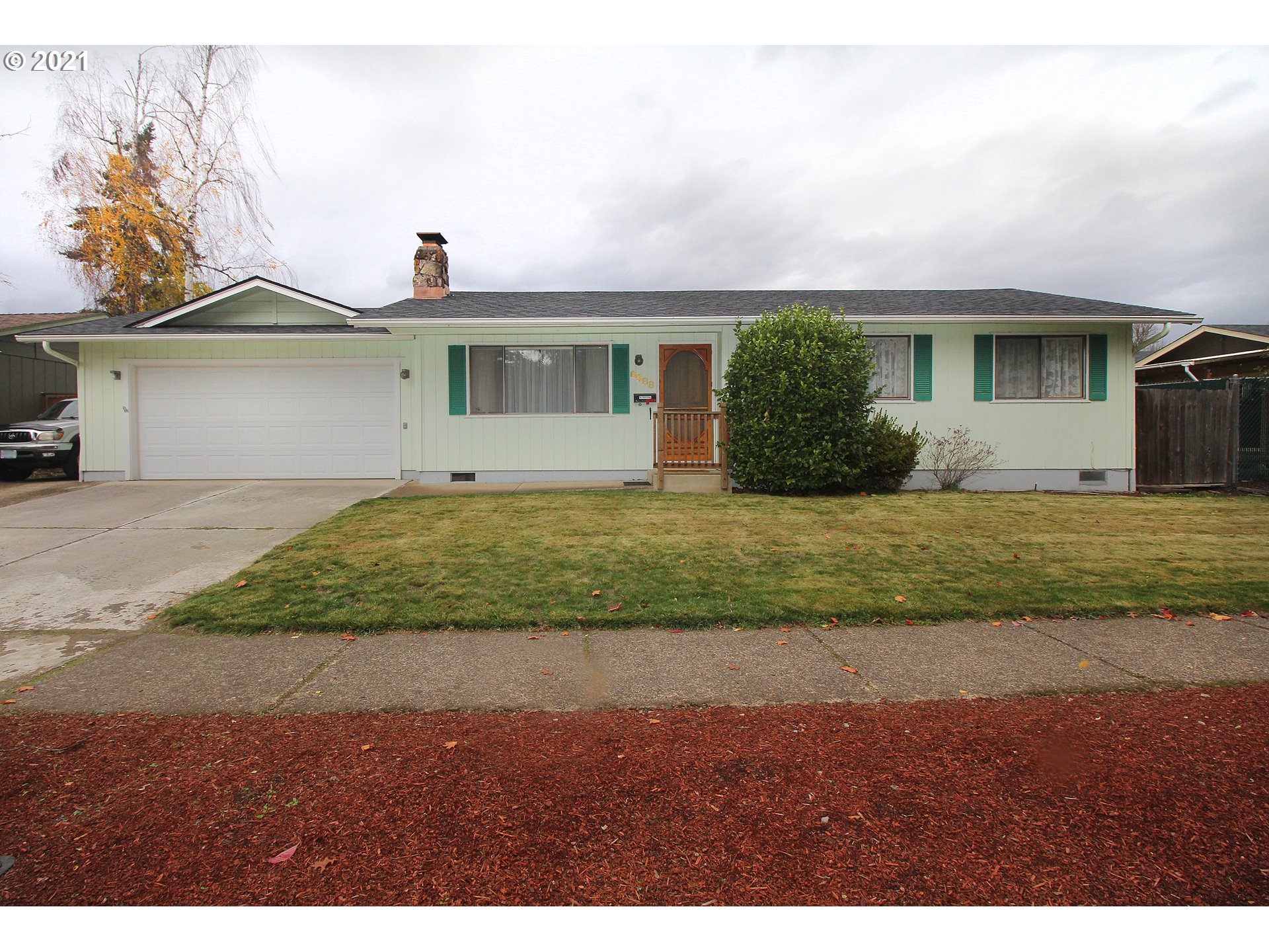 6988 B Street Springfield, OR 97478 - Photo 1 of 31 a front view of a house with a yard and garage